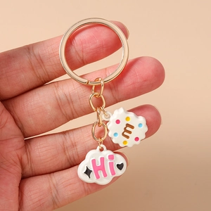 Detail of creative cloud and cookie keychain with golden metal ring and colorful pendants