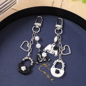 Detailed view of elegant beaded heart keychains with camellia and mini jacket pendants