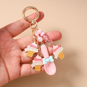 Detail of pink ice cream keychain with beads and Treat Yo Self spoon charm
