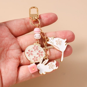 Detail of beaded keychain with cute cat, rabbit and cherry blossom lantern charms