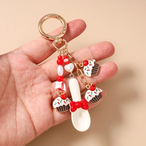 Detailed view of dessert themed keychain with cupcake charms and a small spoon