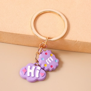 Detail of purple cloud and cookie charms with golden metal key ring and chain