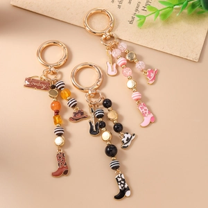 Western cowboy style beaded keychain set with guitar, boots and hat pendants