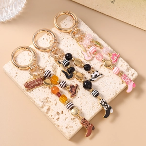 Western style guitar and cowboy boot beaded keychains with golden metal ring and charms