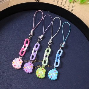Colorful biscuit keychains with chunky chains in pink, purple, green and blue on tray