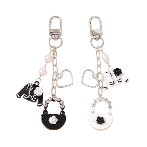 Beaded heart keychain with camellia coat and quilted handbag pendants in black and white