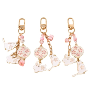 Pastel pink and white enamel bunny and cat keychains with cherry blossom lanterns