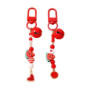 Beaded watermelon keychain with red bell and lobster clasp on white background