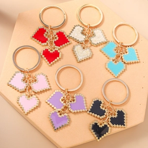 Pixel art mosaic heart keychains in six colors with gold rings and enamel charms