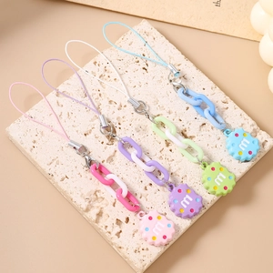 Detailed view of colorful biscuit-shaped resin charms on chunky link chains with m letter