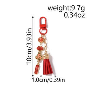 Detailed view of red tassel keychain with gold Fu character and auspicious cloud charms
