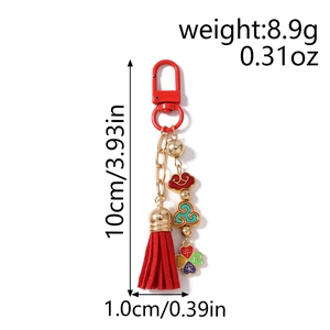 Detail of red tassel keychain with lucky charm, sycee and peace blessing pendant