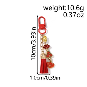Detail of red tassel keychain with gold ingots and cloud charms showing dimensions and weight