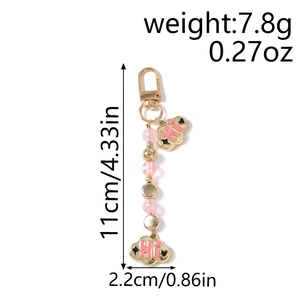 Detail view of pink beaded keychain with golden cloud pendant and size dimensions