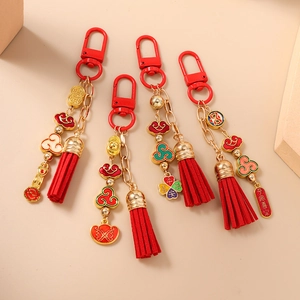 Set of four Chinese style beaded keychains with red tassels and gold lucky charms