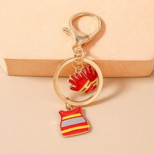 Detailed view of red firefighter uniform and gloves charms on a gold keychain