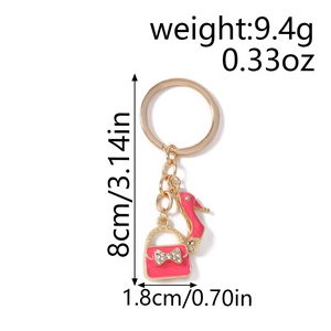Detail showing dimensions of pink enamel handbag and high heel keychain with gold rings