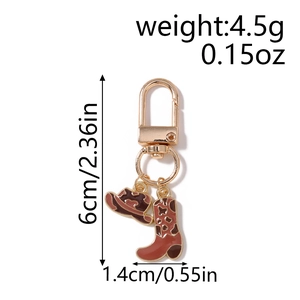 Vue détaillée du porte-clés chapeau et botte de cowboy avec dimensions et poids indiqués