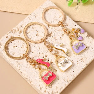 Chic enamel handbag and high heel shoe keychain set with rhinestones in pink, white, and purple