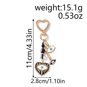 Detail showing dimensions and weight of the gold evil eye heart keychain