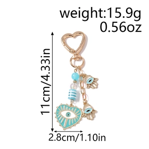 Detail view of Evil Eye heart keychain with Hamsa charms and dimensions 11cm x 2.8cm