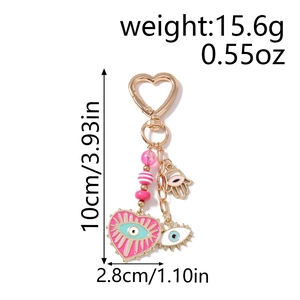 Pink heart evil eye keychain with hamsa hand charm showing weight and height specifications