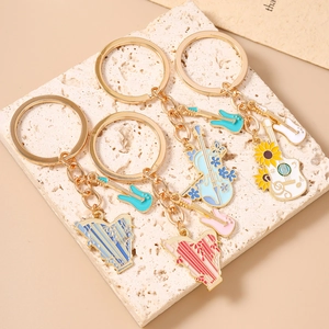 Golden musical instrument keychains with enamel harp, violin, guitar and sunflower charms