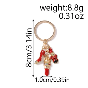 Detailed view of high heel and lipstick charms on a gold keychain with size dimensions