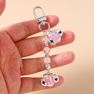 Detail of pink beaded keychain with silver cloud charms featuring HI text and hearts