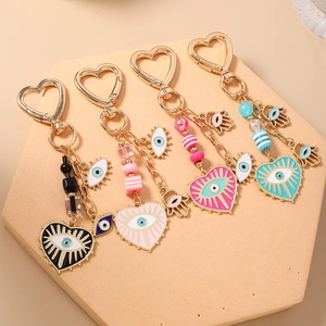 Evil Eye heart-shaped keychains in four colors with Hamsa Hand and gold metal accents