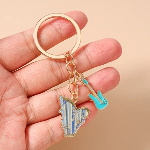 Detail of golden guitar and harp musical instrument charms on a keychain pendant