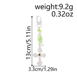 Detail view of gothic cross keychain with striped green beads showing exact size and weight