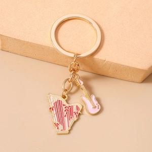 Detailed close-up of golden harp and guitar charms on a musical theme keychain