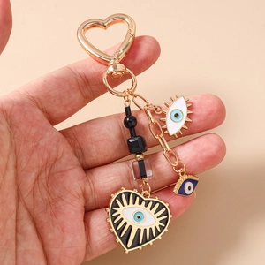 Detail of evil eye keychain with heart lobster clasp and colorful beads in hand