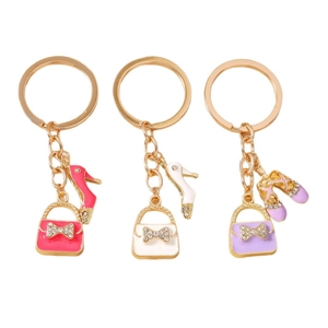 Three-piece gold keychain set featuring rhinestone handbag and high heel charms