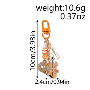 Detailed view of musical instrument keychain with violin and guitar charms and dimensions