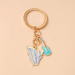 Detailed close-up of musical harp and electric guitar blue enamel gold keychains