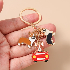 Detail of metal enamel Corgi keychain featuring dogs and a car with I love drive text