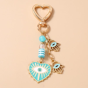 Detail view of Evil Eye heart keychain with Hamsa Hand charms and gold-tone alloy hooks