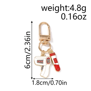 Detail view of medical keychain showing thermometer and test tube dimensions and weight