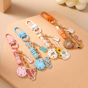 Creative music themed beaded keychains with guitar and violin charms in four colors