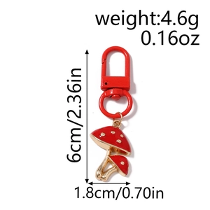 Detail view of red spotted mushroom keychain with dimensions 6cm by 1.8cm on white background