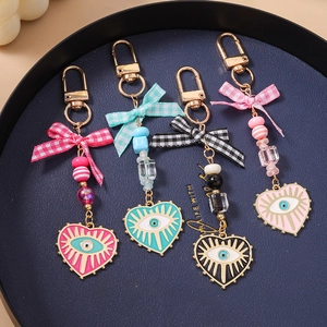 Set of four evil eye heart keychains with checkered bows and colorful beaded charms