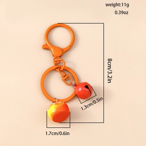 Detailed view of creative orange fruit keychain with red bell and secure metal ring