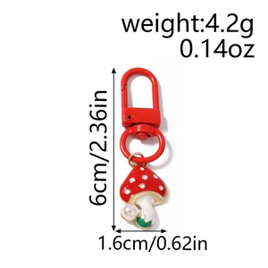 Detail showing dimensions of red mushroom keychain with pearls weighing 4.2g and 6cm long