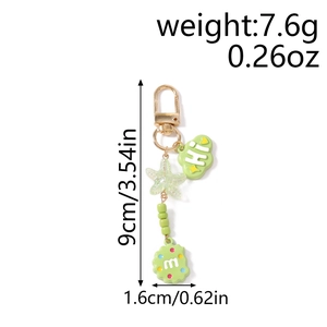 Detail view of green cloud charm keychain with bead starfish and lobster clasp