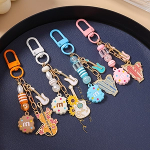Detailed macro view of enamel violin and guitar charms on beaded music themed keychains