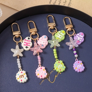 Starfish cloud bead keychains in white, pink, green, and purple with gold clips