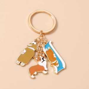 Detail of three cute enamel Corgi dog charms with gold plating for keychains and bags