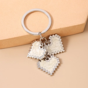 Detailed macro view of pixel heart pendants with wavy texture on a silver keyring